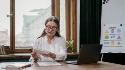 Ontario teacher reviewing SHSM programme requirements at a desk with a laptop and a printed guide