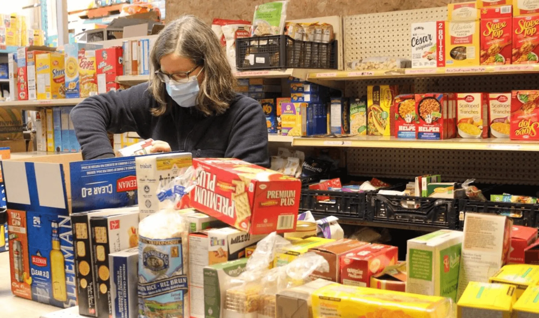 Staff member sorting shelved donations at Guelph Food Bank ahead of the SHSM ICE design challenge