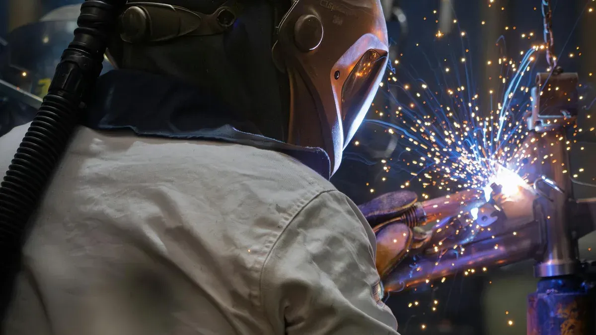 Student in a skilled trades workshop wearing safety equipment